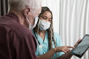 Doctor consulting with older patient.