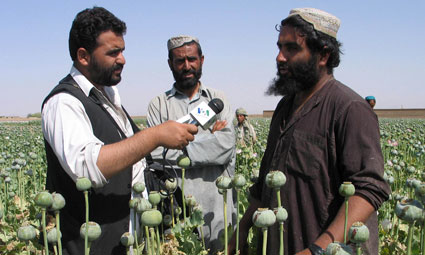 Photo of Reporter Interviewing Afghan Poppy Cultivators