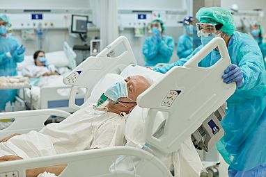 A photo of a man in a hospital bed.