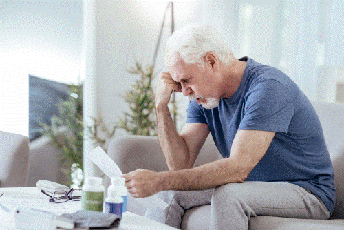 Photo of a man trying to understand his medications.