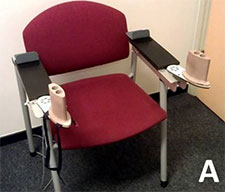 A chair with a The BATRAC upper extremity training device attached.