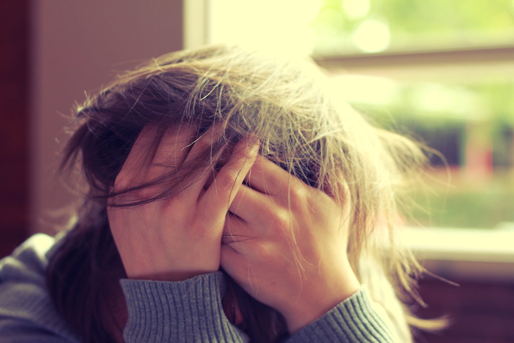 Woman with head in her hands.