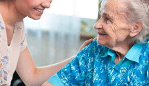 Photo: A caregiver and older woman in an assisted living facility