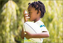 A photo of a child using an asthma inhaler.