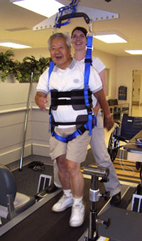 man using a body-weight-assisted treadmill