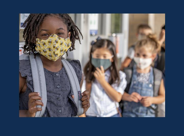 A photo of children in masks.