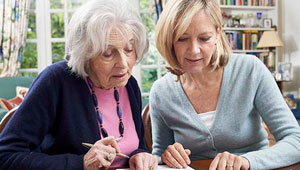 Photo: Daughter Assisting her Mother with Bills