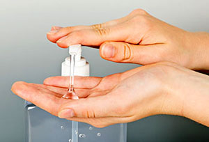 Photo of Person Using Hand Sanitizer