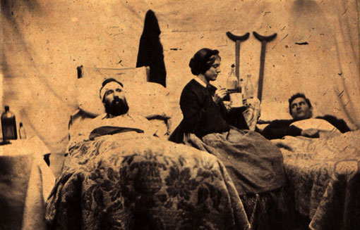 An 1864 photograph of a nurse attending to men wounded in the Batte of Nashville.