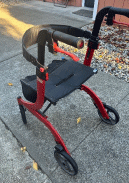seated wheeled walker with large wheels and a wide base