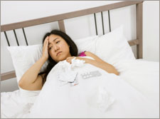 Photo: Woman in Pain Resting in Bed Photo: Woman in Pain Resting in Bed