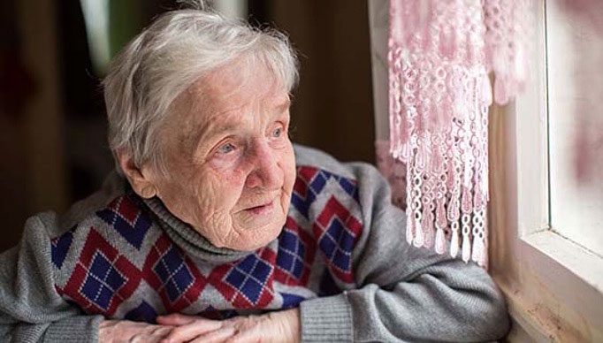 Photo: Old Woman Looking Out Window