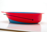 A plate with a slanted bottom can help users to gather food on one side without scooping. 