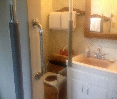 Photo: Small Bathroom with Grab Bars and Other Assistive Aids