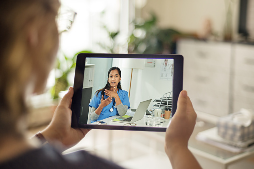 A photo of a person using a tablet to complete her CEUs.